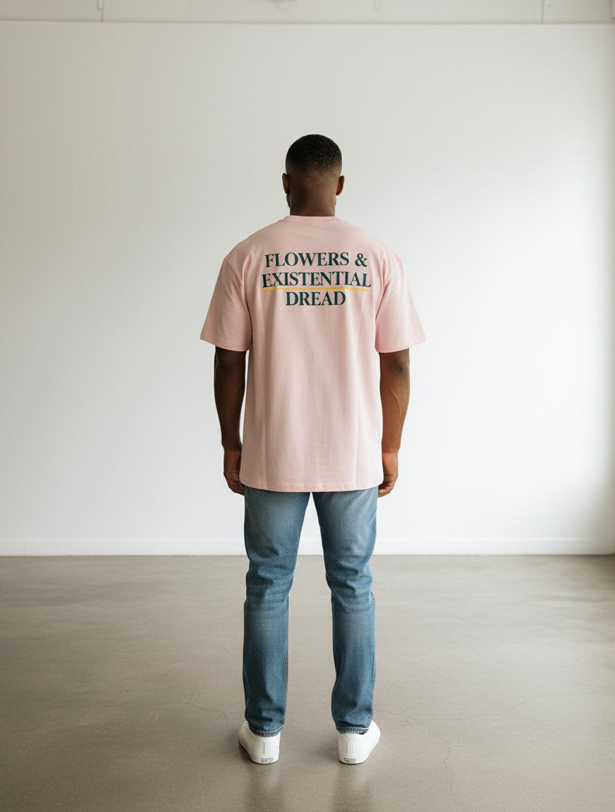 mi-DONE oversized pink cotton t-shirt with Flowers & Existential Dread back print, worn by a man with blue jeans.