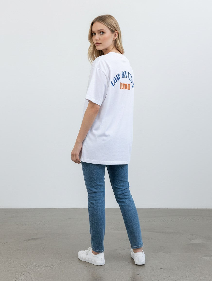 mi-DONE white oversized cotton t-shirt with Low Battery graphic print on back, worn by a woman with blue jeans