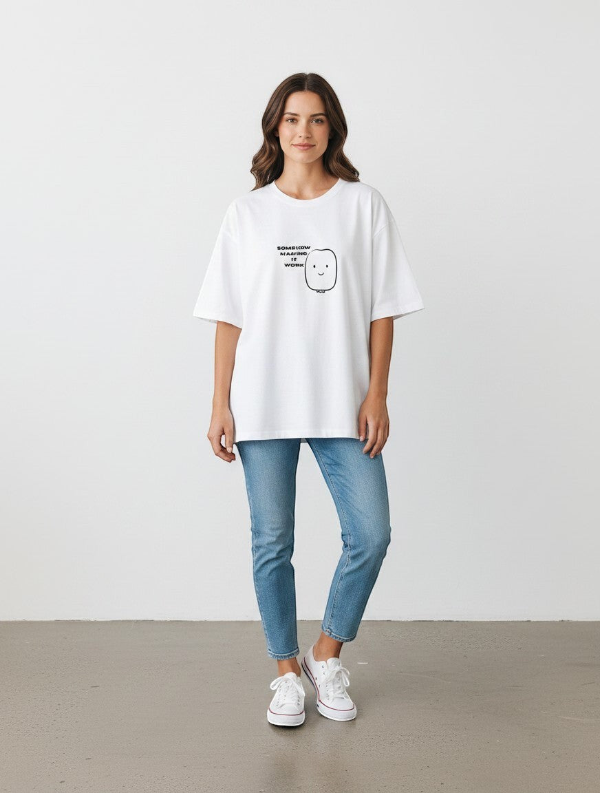 mi-DONE white oversized cotton t-shirt with a cute graphic print, worn by a woman with blue jeans and white sneakers.