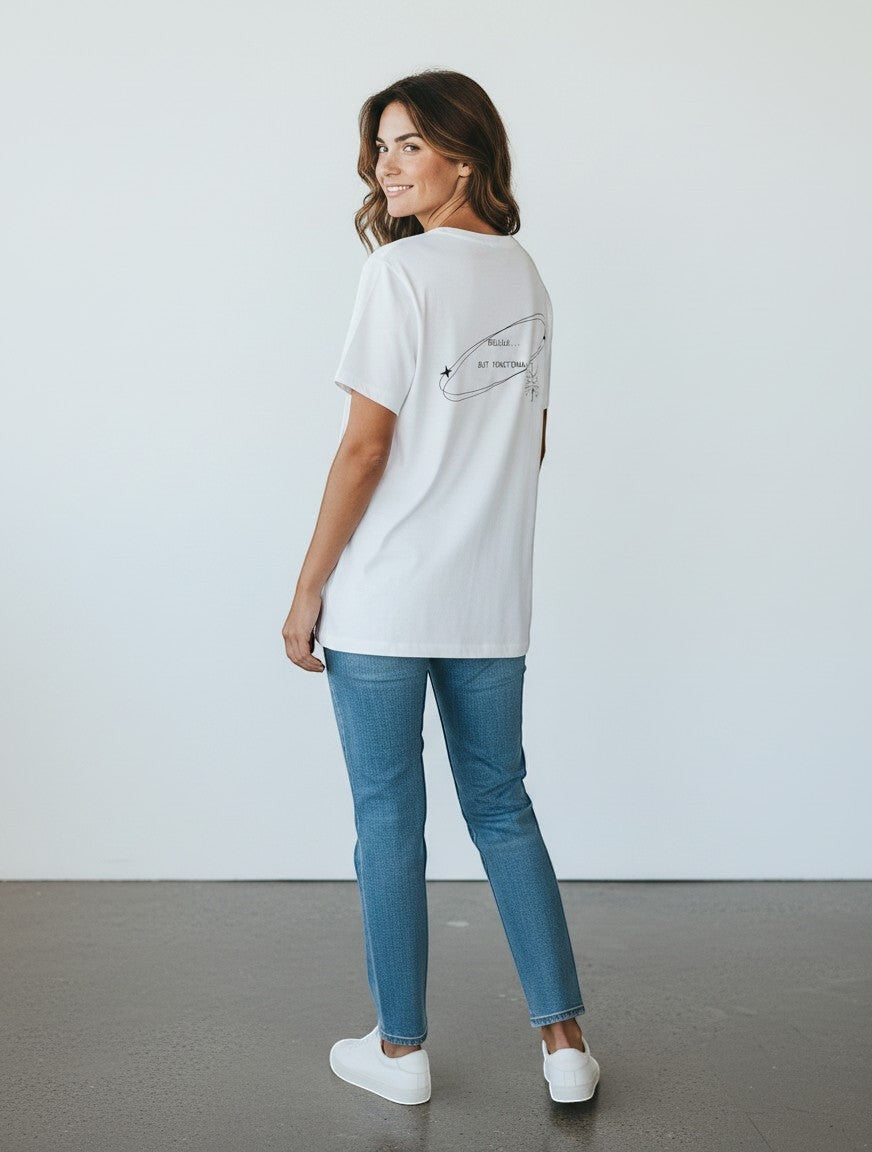 mi-DONE white oversized cotton t-shirt with Delulu But Functional graphic print, worn by a woman with blue jeans
