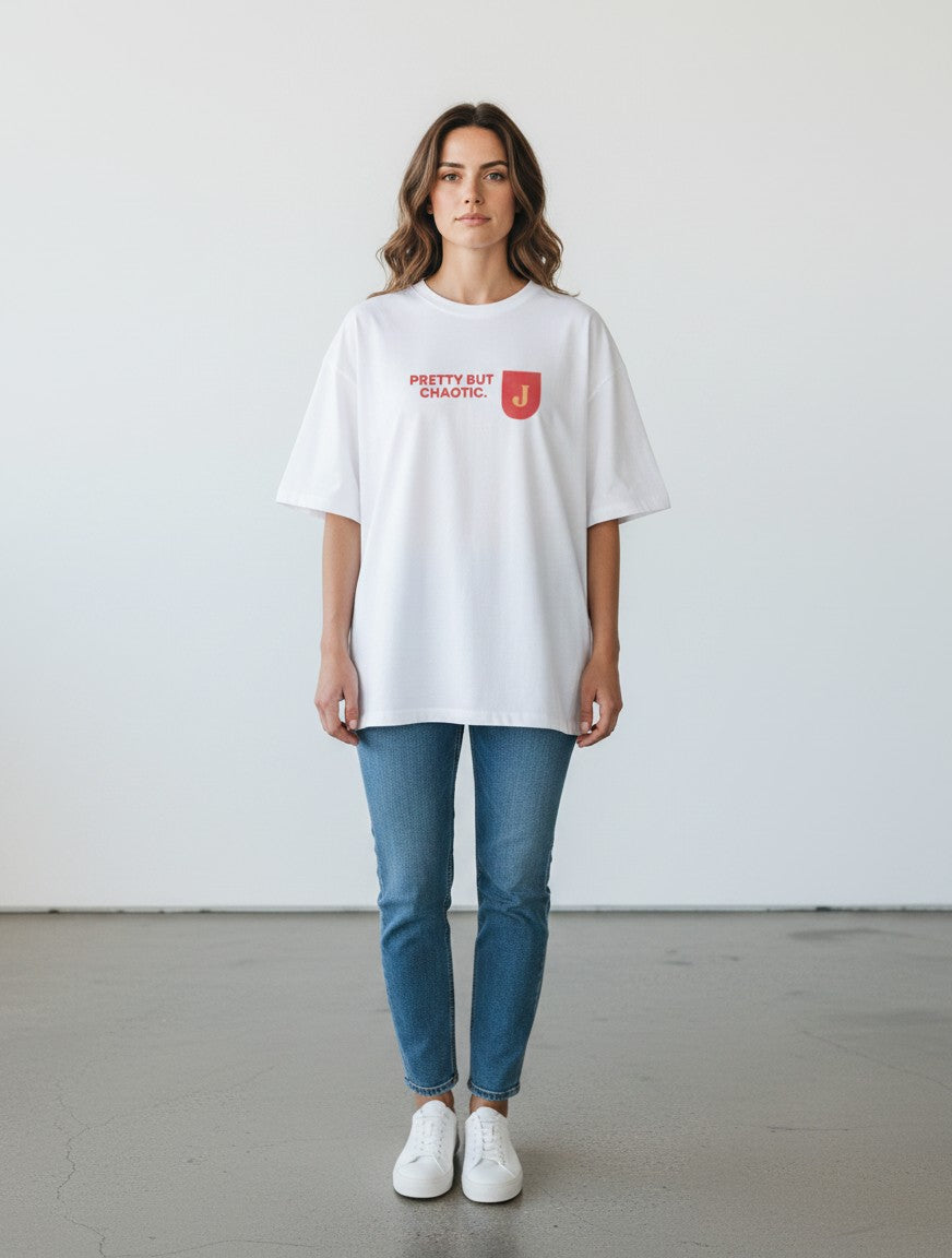 Woman wearing a white mi-DONE oversized cotton t-shirt with Pretty But Chaotic text print and blue jeans