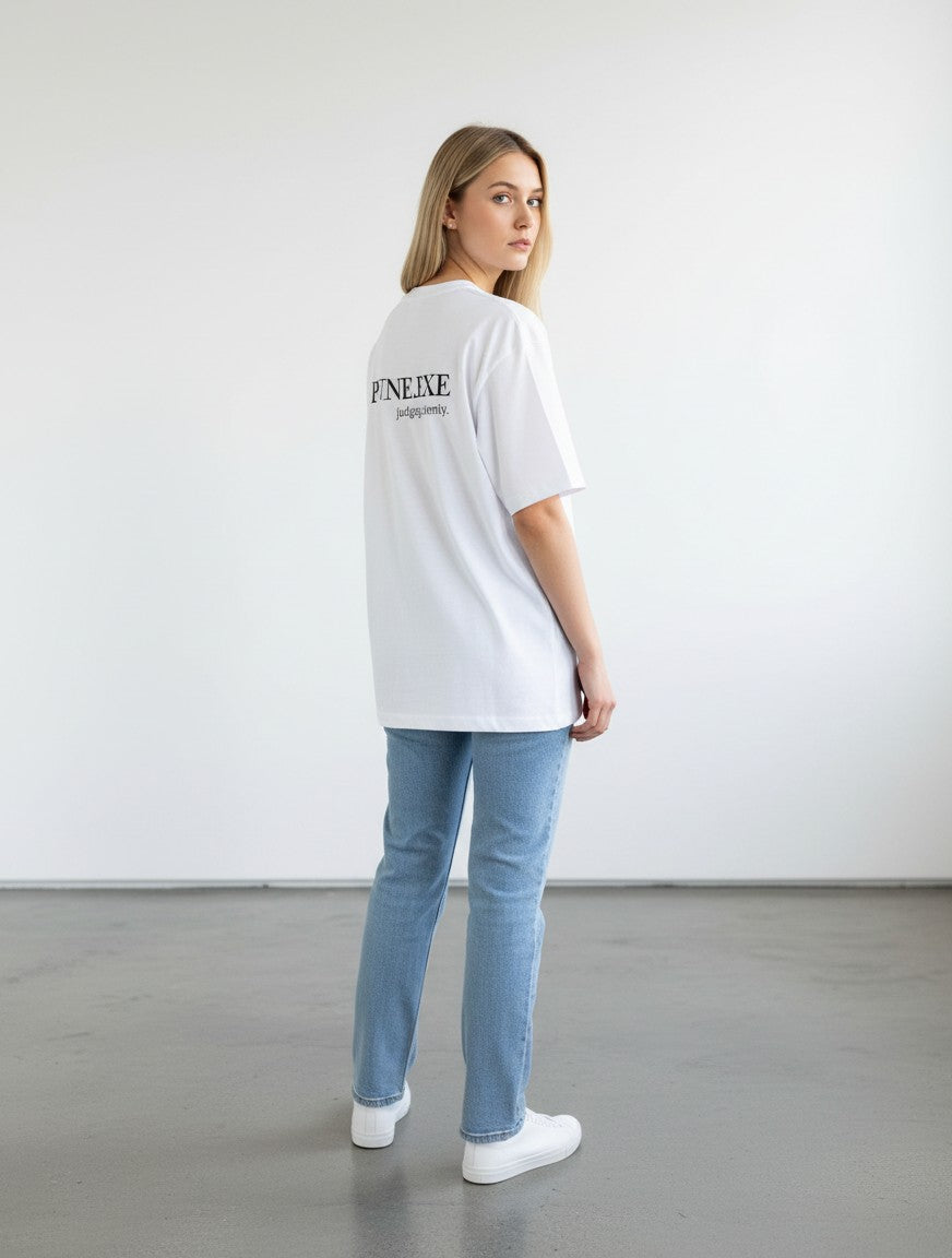 mi-DONE white oversized cotton t-shirt with Opinion Loading text on back, worn by a woman with blue jeans