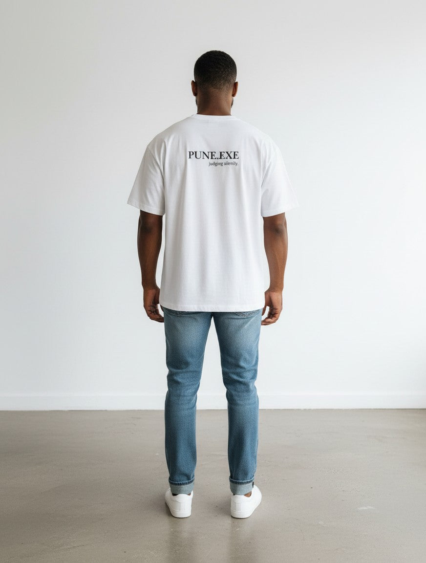 mi-DONE white oversized cotton t-shirt with PUNE.EXE graphic on back, worn by a man with blue jeans and white sneakers