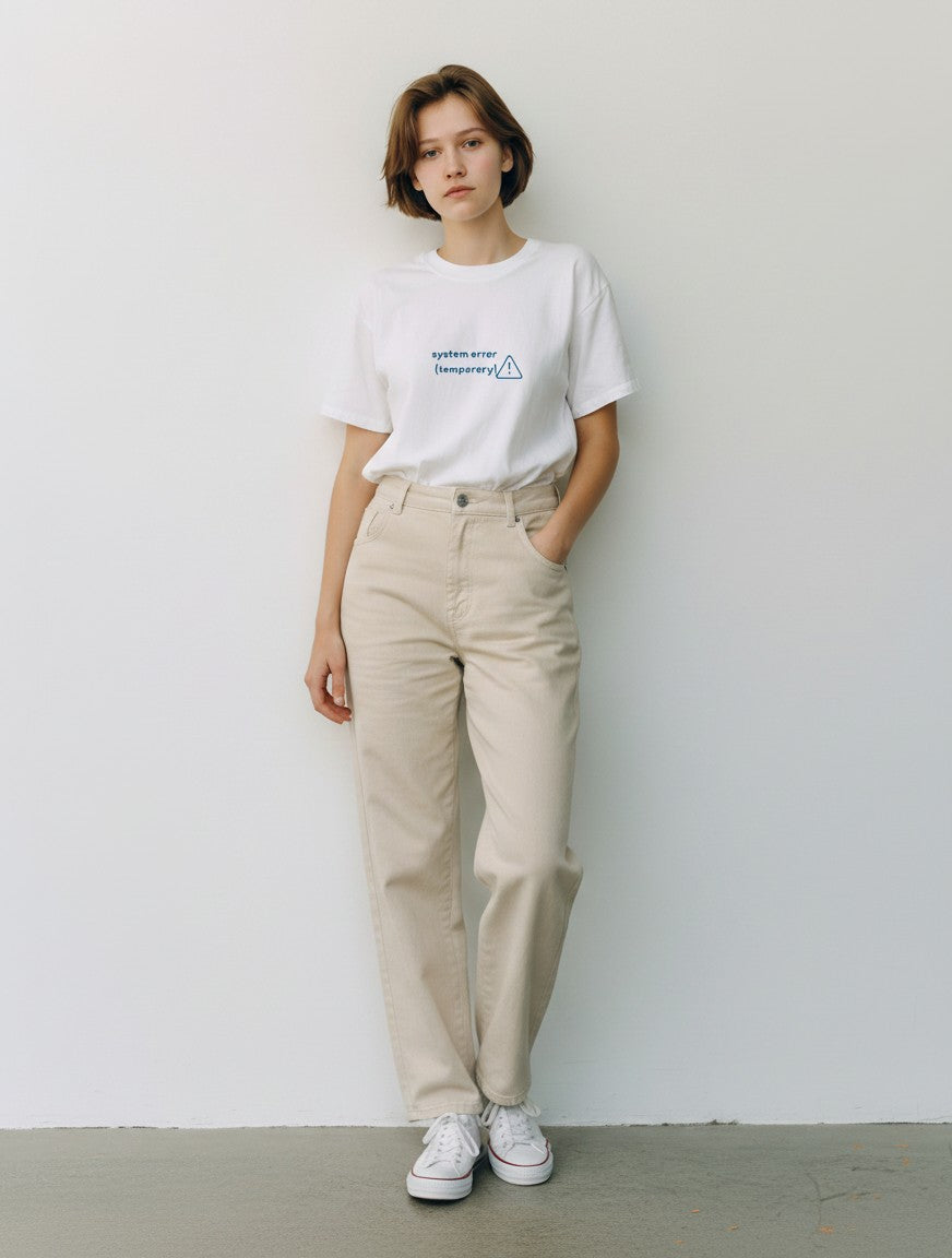 Model wearing a white mi-DONE oversized cotton t-shirt with System Error text print and beige jeans
