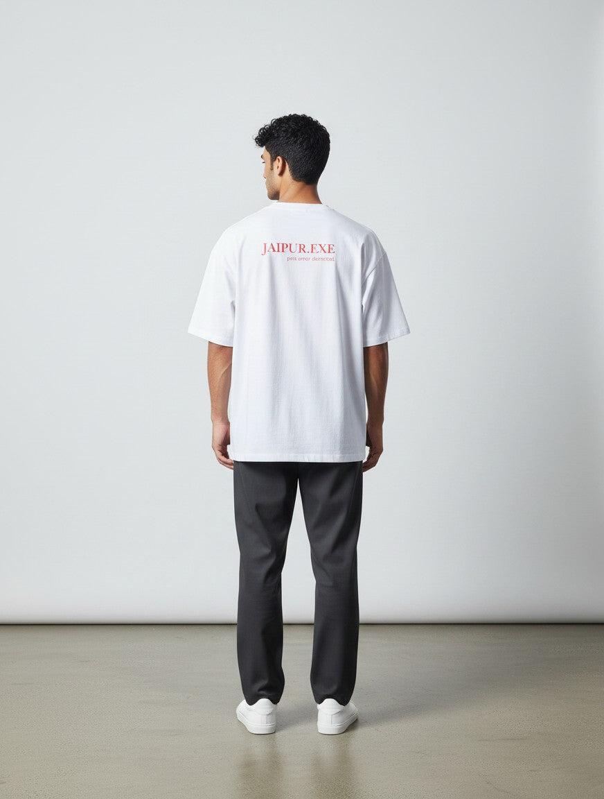 mi-DONE white oversized cotton t-shirt with red Jaipur.exe graphic on the back, worn by a man with dark trousers.