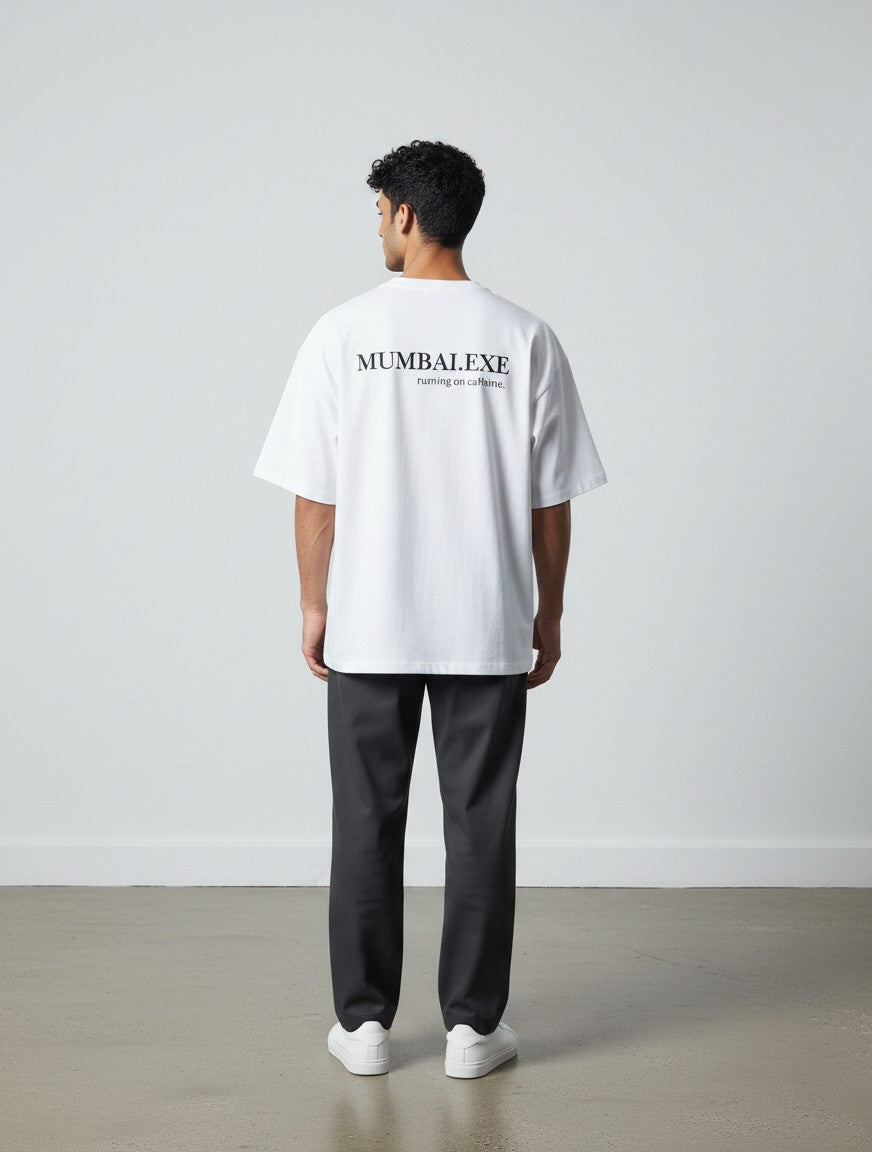 mi-DONE white oversized cotton t-shirt with Mumbai graphic print on the back worn by a man with dark trousers