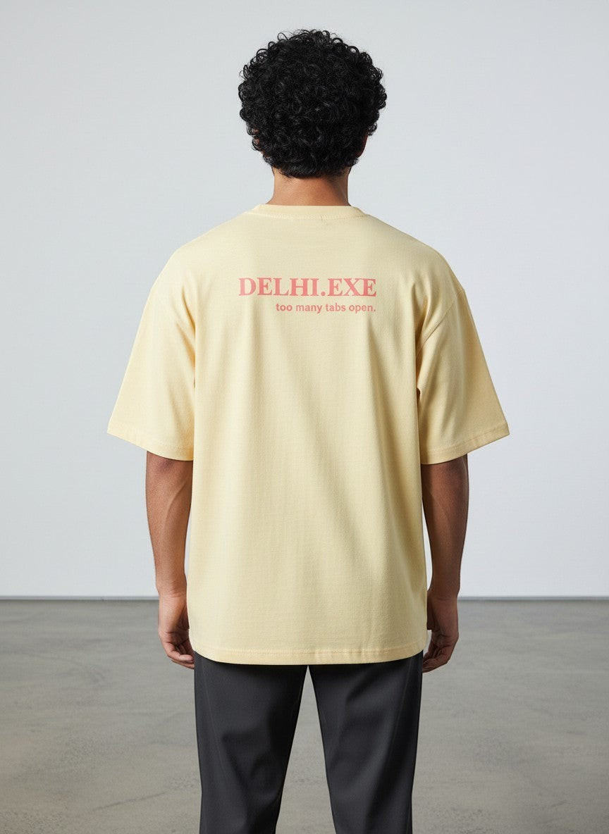 mi-DONE oversized yellow cotton t-shirt with Delhi.exe graphic print on the back, worn by a man from behind.