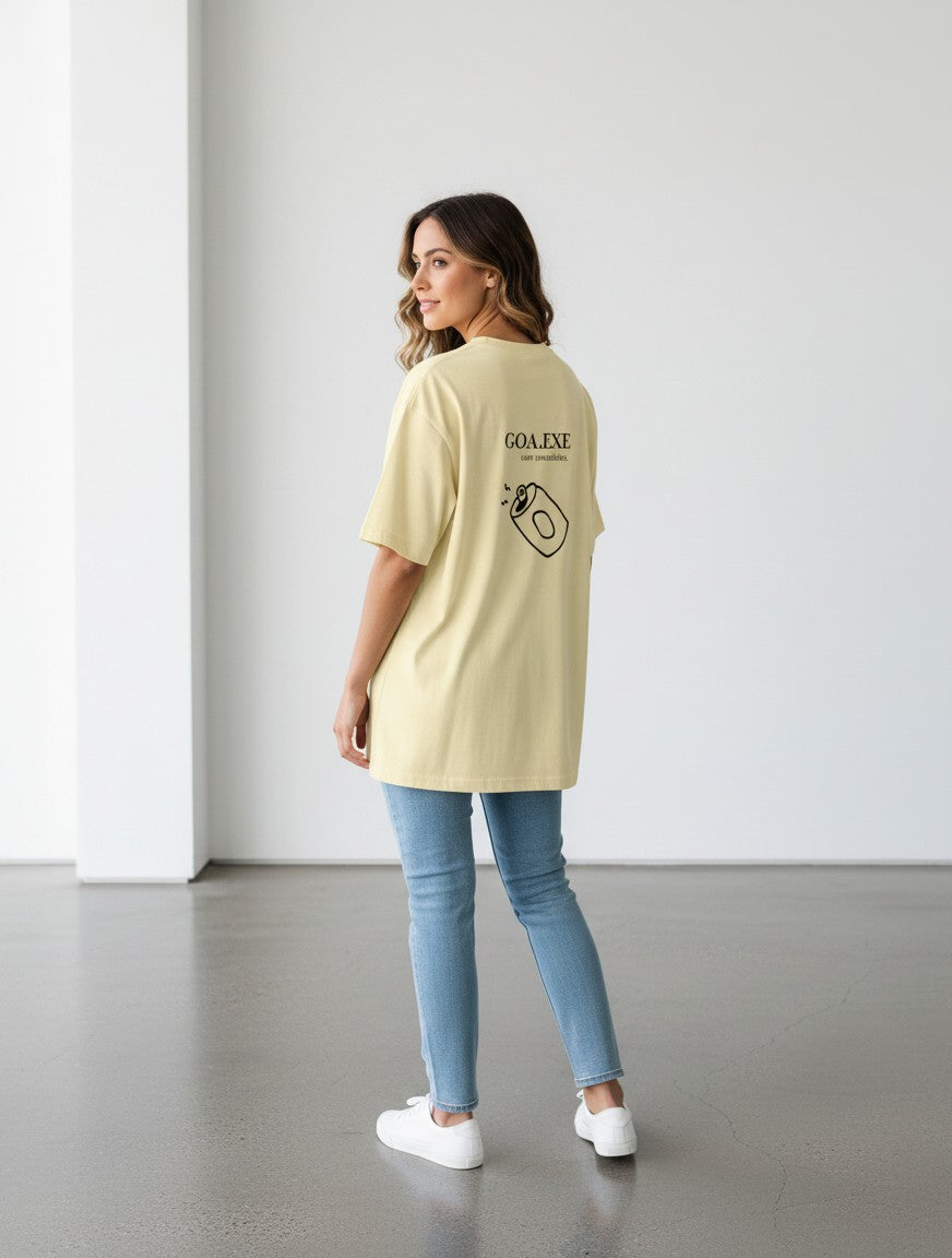 Model wearing a yellow mi-DONE oversized cotton t-shirt with Goa graphic print on the back, paired with blue jeans.